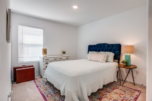 carpeted bedroom featuring multiple windows