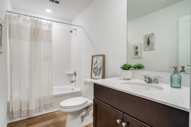 full bathroom with shower / bath combo with shower curtain, wood-type flooring, toilet, and vanity