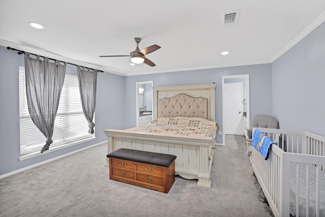 carpeted bedroom with ceiling fan, crown molding, and a crib