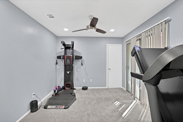 workout room featuring ceiling fan and light colored carpet