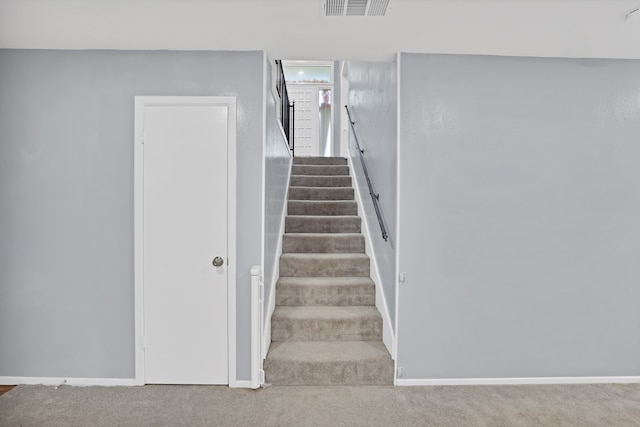 stairs featuring carpet flooring