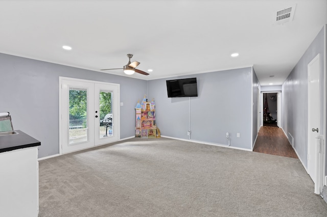 recreation room with ceiling fan, french doors, and dark colored carpet