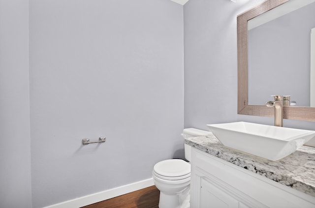 bathroom featuring vanity, toilet, and wood-type flooring