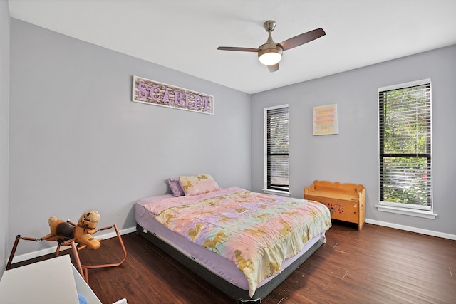 bedroom with dark hardwood / wood-style floors, multiple windows, and ceiling fan