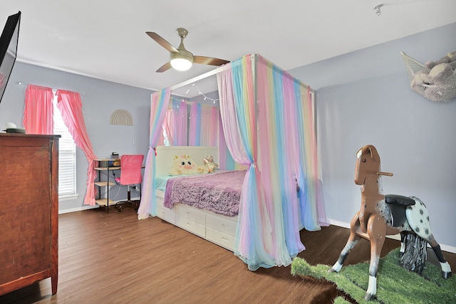 bedroom with ceiling fan and hardwood / wood-style flooring