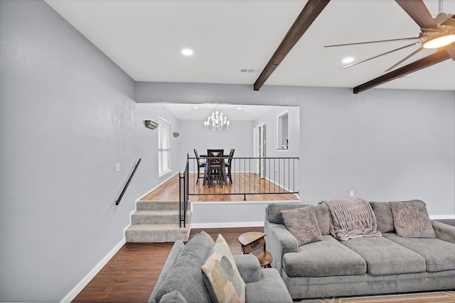 living room featuring beam ceiling, ceiling fan with notable chandelier, and hardwood / wood-style flooring