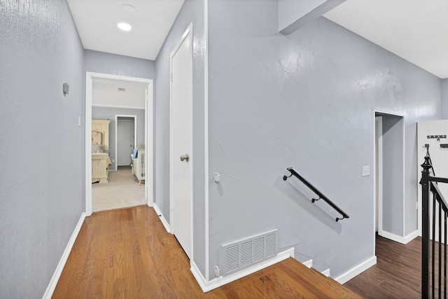 corridor with hardwood / wood-style floors