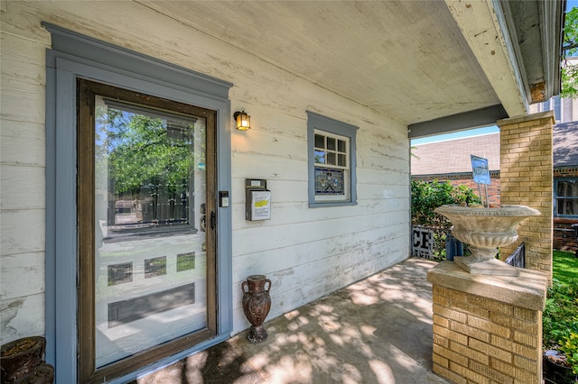 view of exterior entry with covered porch