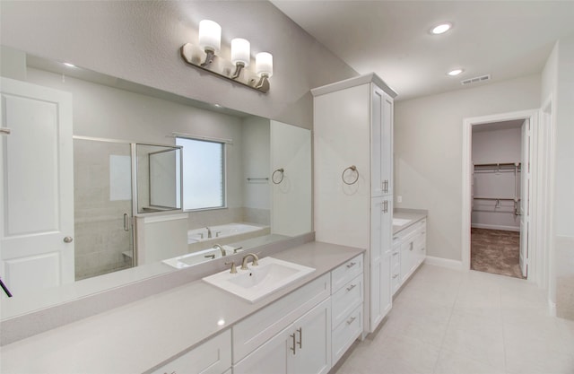 bathroom featuring vanity, tile patterned floors, and a shower with door