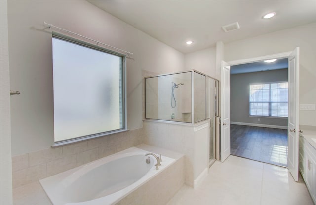 bathroom with plus walk in shower and tile patterned flooring