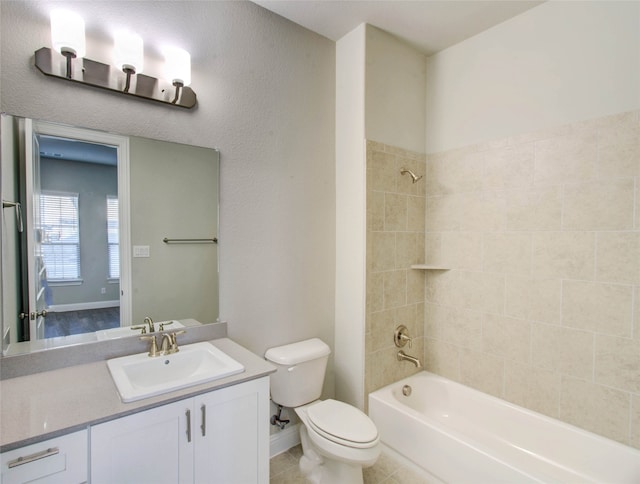 full bathroom with toilet, tile patterned flooring, tiled shower / bath combo, and vanity