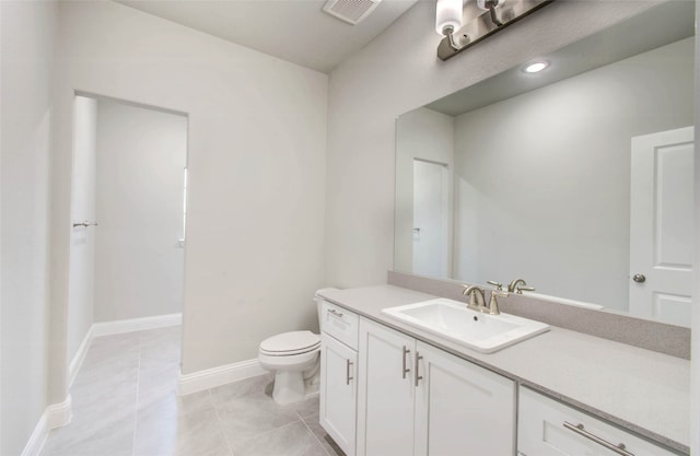 bathroom with toilet, tile patterned flooring, and vanity