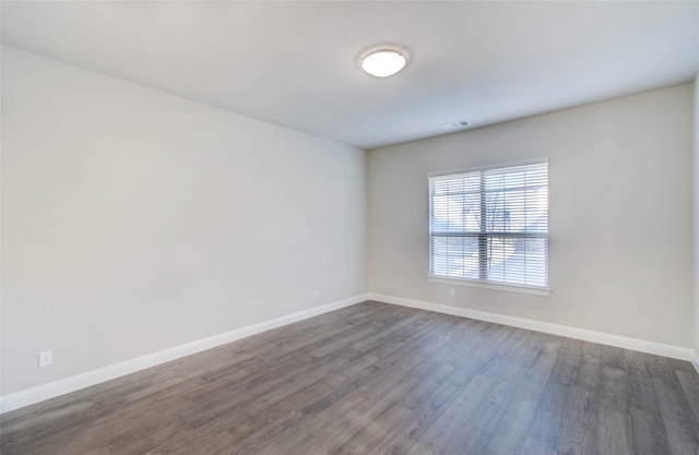 unfurnished room with dark hardwood / wood-style floors