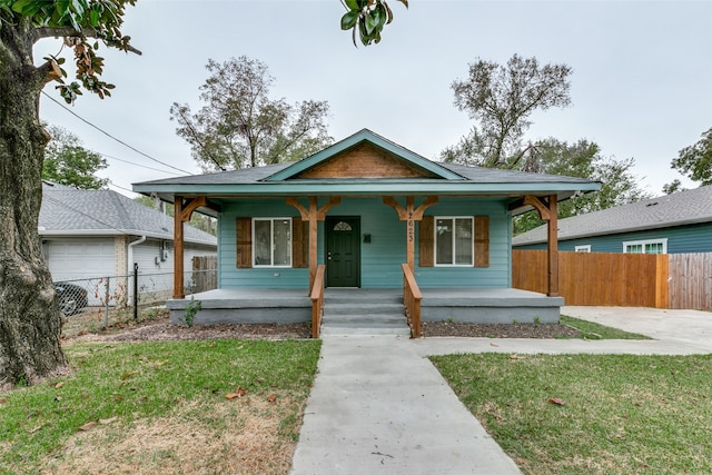 bungalow featuring a porch and a front yard