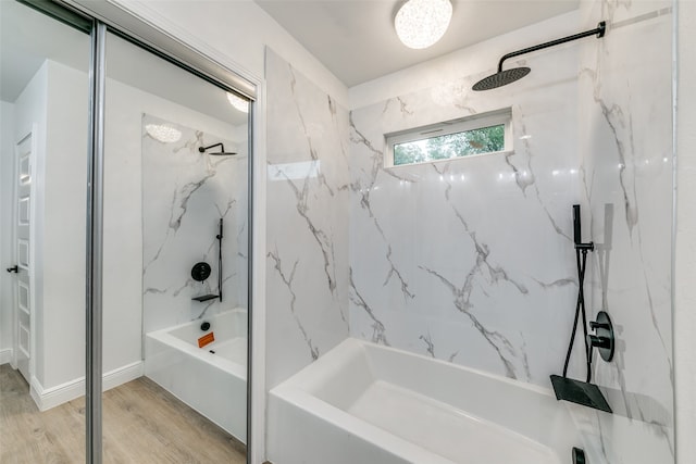 bathroom featuring tiled shower / bath and wood-type flooring