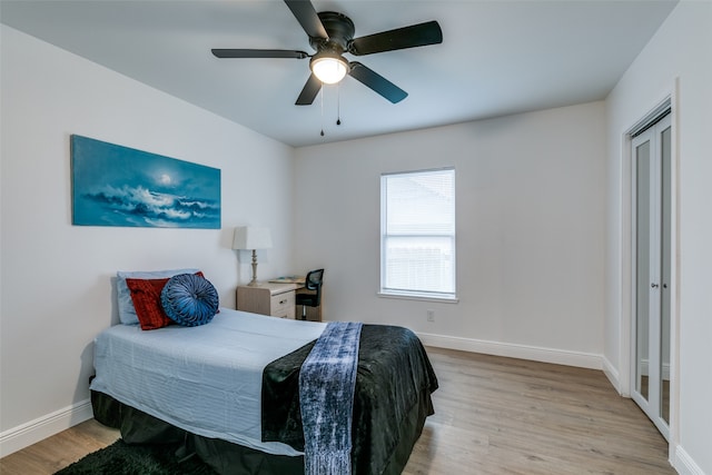 bedroom featuring a closet, light wood-type flooring, and ceiling fan