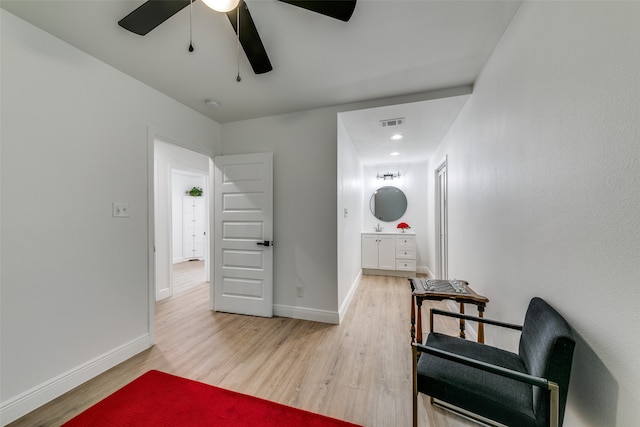 living area featuring hardwood / wood-style flooring and ceiling fan