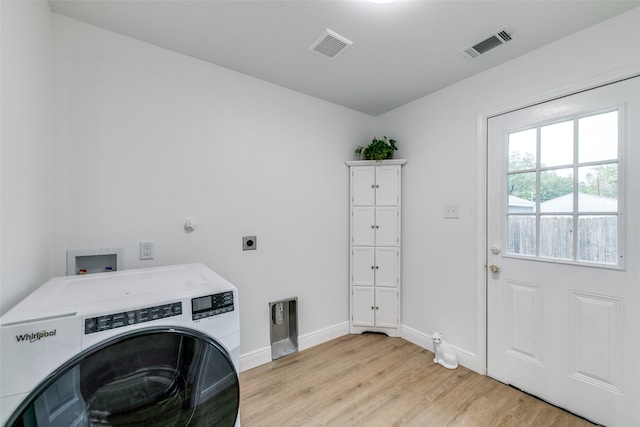 laundry area featuring washer / dryer and light wood-type flooring