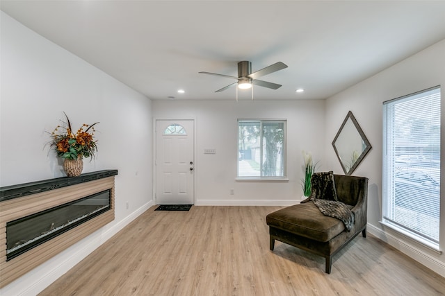 sitting room featuring ceiling fan, plenty of natural light, and light wood-type flooring