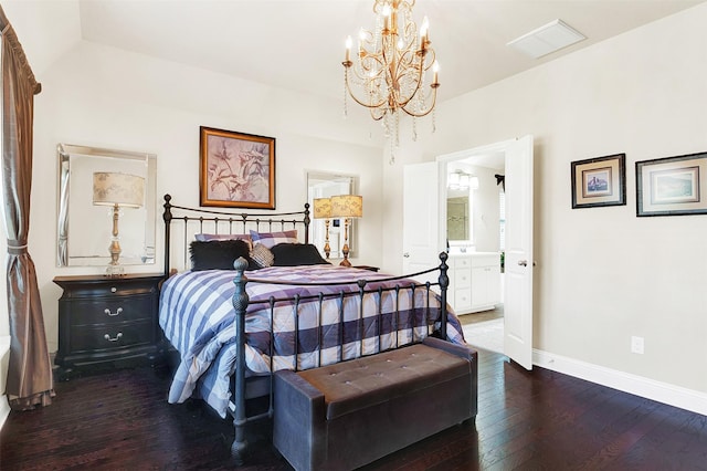 bedroom featuring dark wood-type flooring, connected bathroom, and a notable chandelier