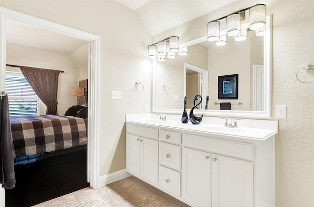 bathroom with vanity, tile patterned flooring, and vaulted ceiling