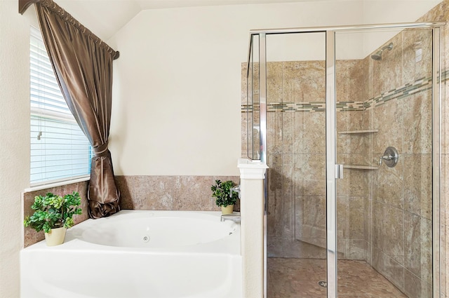 bathroom featuring lofted ceiling and separate shower and tub