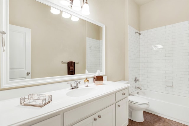 full bathroom featuring tiled shower / bath, vanity, toilet, and tile patterned floors