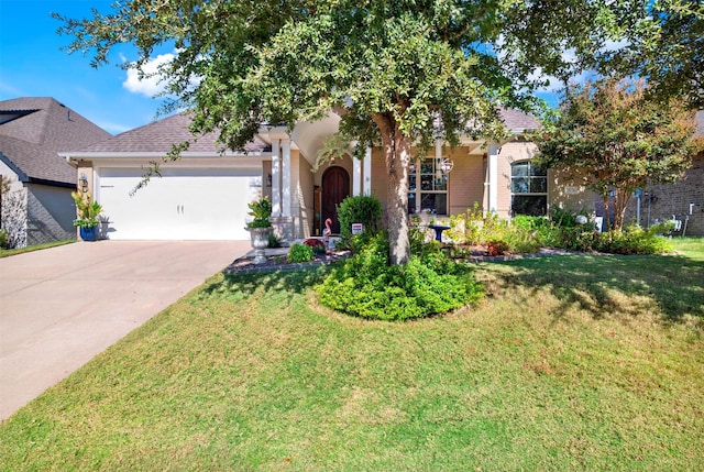 view of front of house with a garage and a front yard