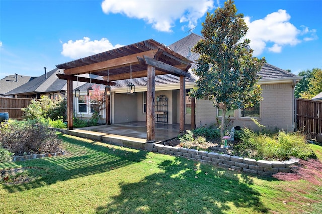 back of house featuring a pergola, a patio area, and a lawn