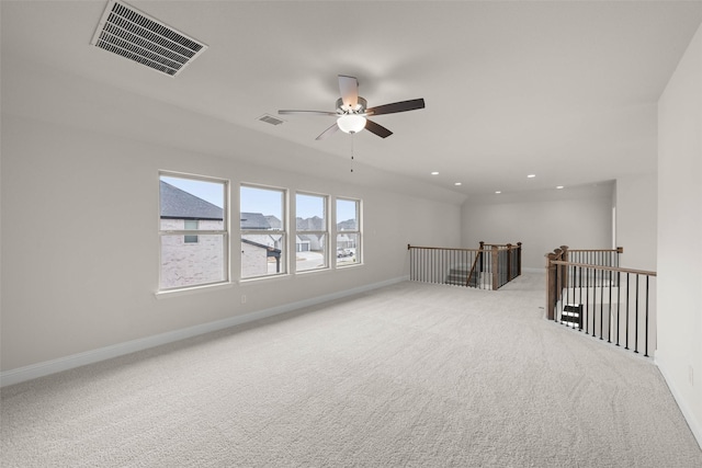 spare room with ceiling fan and light colored carpet