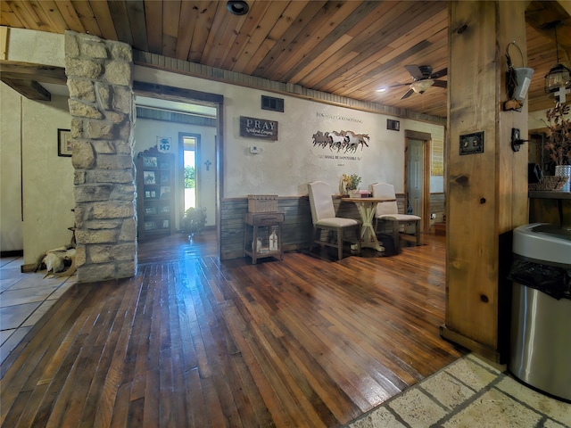 living room featuring ornate columns, ceiling fan, wooden ceiling, and dark hardwood / wood-style floors