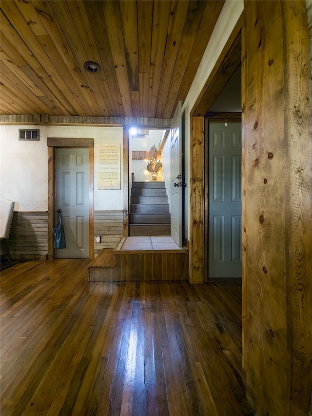 corridor with wood ceiling and dark hardwood / wood-style flooring