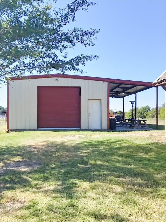 view of outdoor structure featuring a lawn