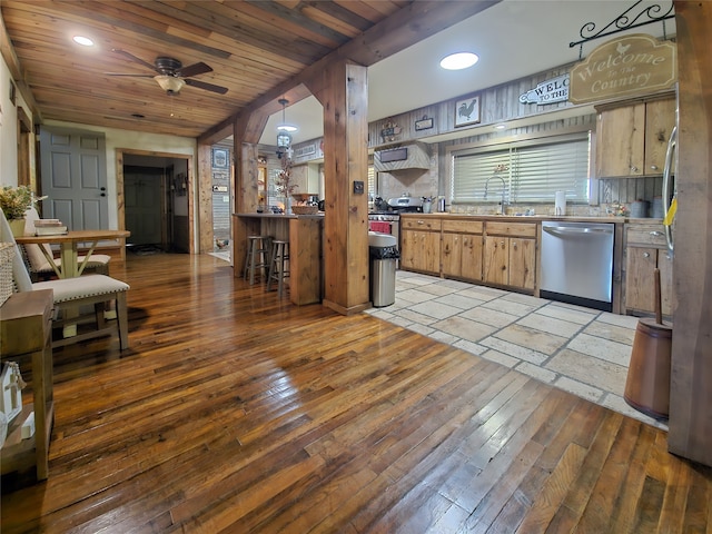 kitchen with tasteful backsplash, ceiling fan, appliances with stainless steel finishes, pendant lighting, and light hardwood / wood-style floors