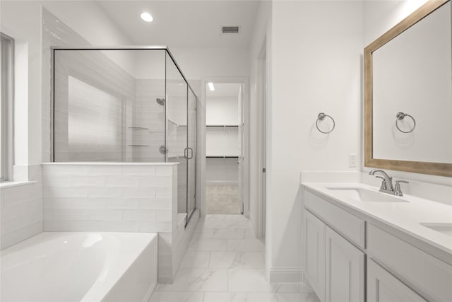 bathroom with marble finish floor, visible vents, a sink, a shower stall, and a bath