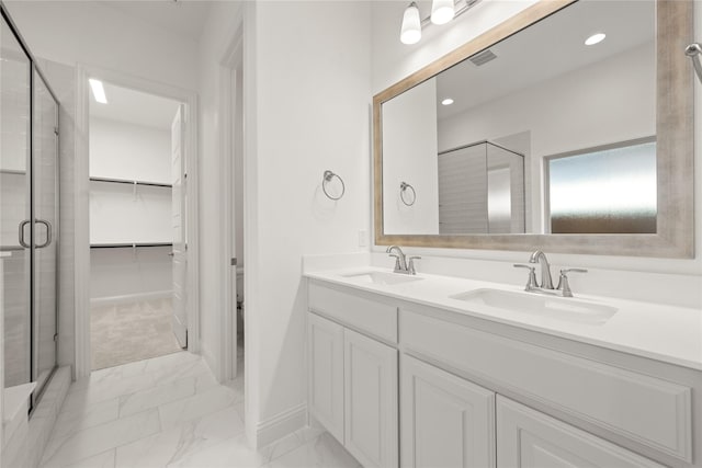 full bath featuring marble finish floor, a shower stall, visible vents, and a sink