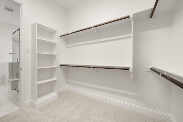 walk in closet with carpet floors and visible vents