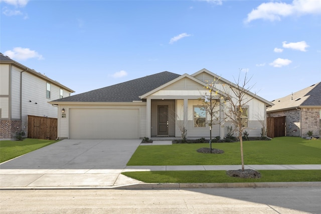 view of front of property with a front yard and a garage