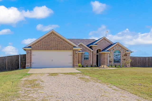 ranch-style house featuring a front yard and a garage