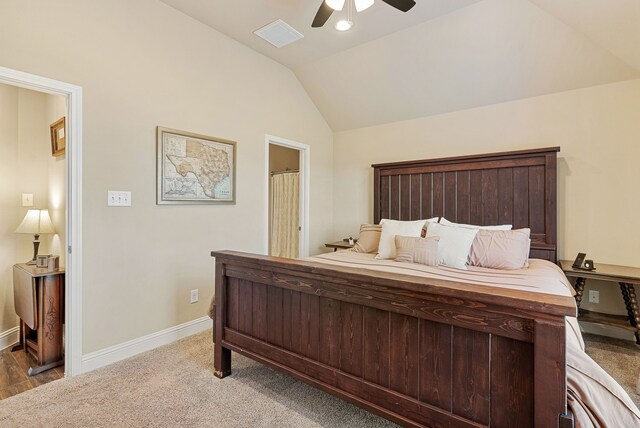 carpeted bedroom with vaulted ceiling and ceiling fan