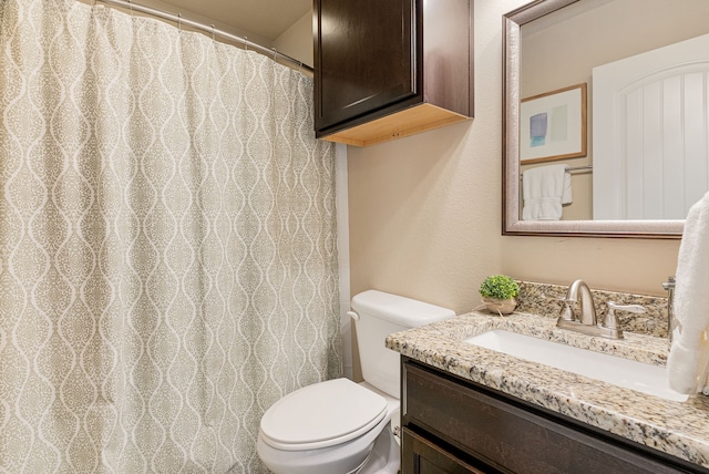 full bath featuring vanity and toilet