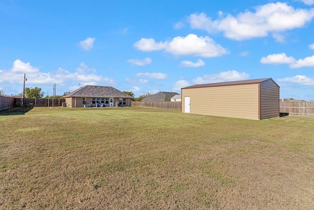 view of yard with an outbuilding and a fenced backyard