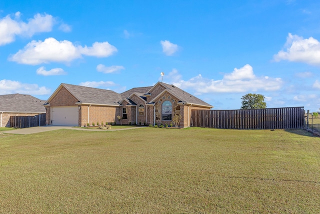 view of front of home featuring an attached garage, fence, a front lawn, and brick siding