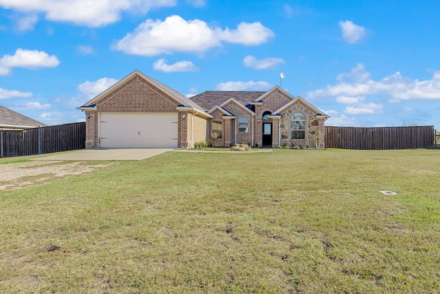 view of front of home featuring a garage and a front lawn