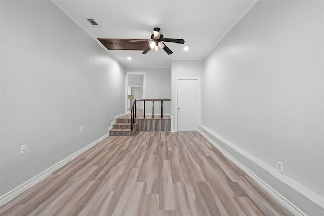 unfurnished room featuring crown molding, light hardwood / wood-style flooring, and ceiling fan