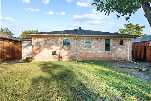 back of property featuring a lawn