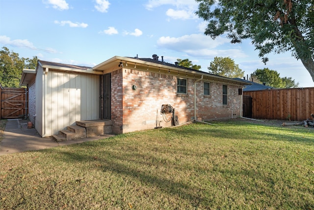 rear view of property featuring a yard