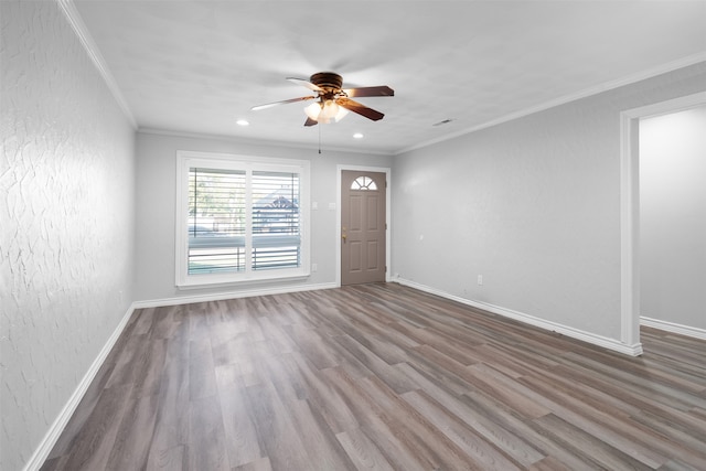 unfurnished room with ceiling fan, ornamental molding, and wood-type flooring