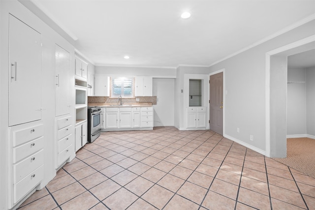 kitchen with sink, stainless steel range with gas stovetop, tasteful backsplash, ornamental molding, and white cabinets