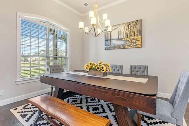 dining area with dark wood-type flooring, plenty of natural light, a chandelier, and ornamental molding